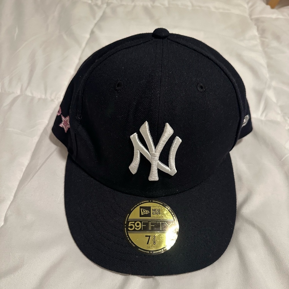 Navy blue Yankees hat from Lids. Pink patch on the side.